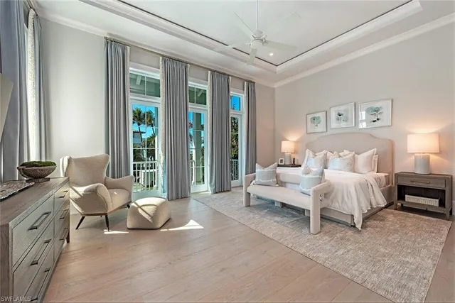 a bedroom with furniture and a large window