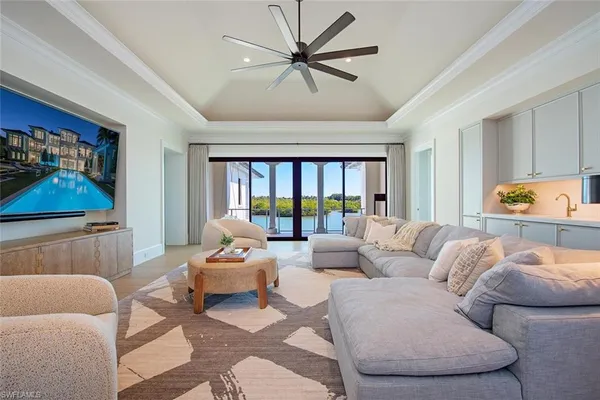 a living room with furniture and a large window with garden view