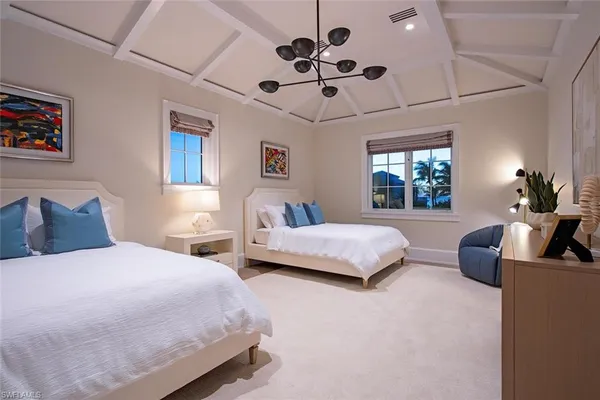 a bedroom with bed and a chandelier