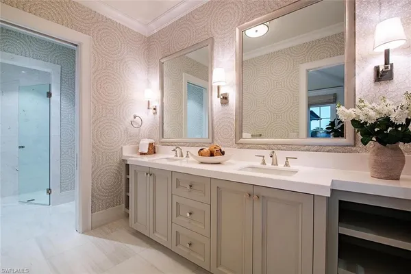 a bathroom with double sink and a mirror