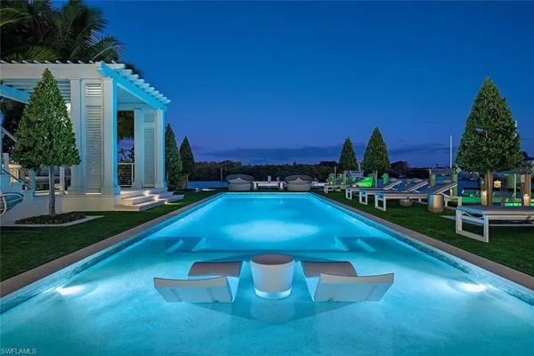 a swimming pool with outdoor seating and yard