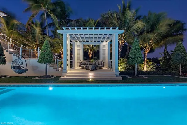 a view of a house with fountain and potted plants
