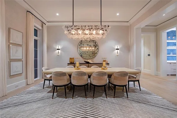 a view of a dining room with furniture and chandelier