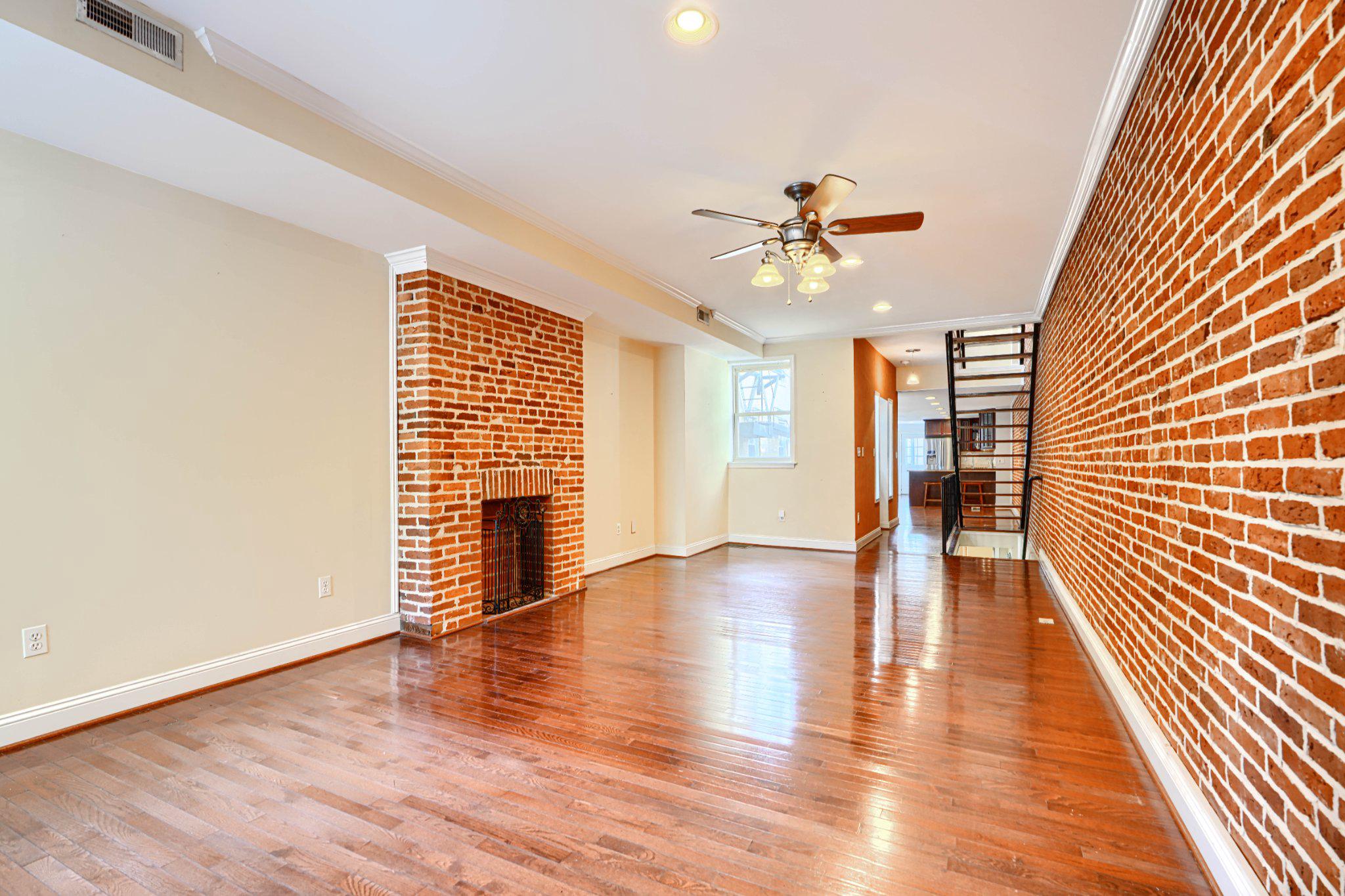 232 South Ann Street Baltimore, MD 21231 - Photo 4 of 62 Living Room Exposed Brick Walls & Hardwood Floors