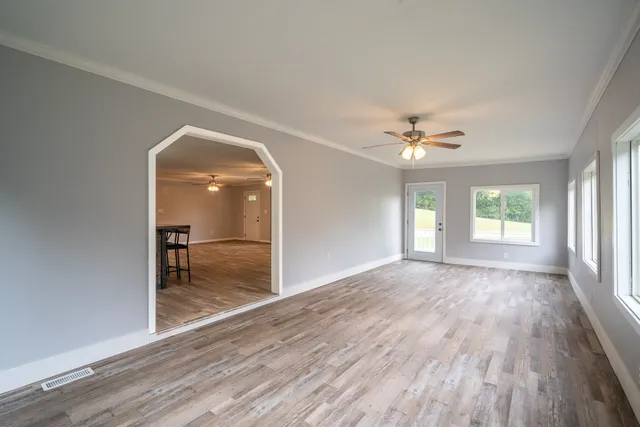 wooden floor in an empty room with a window