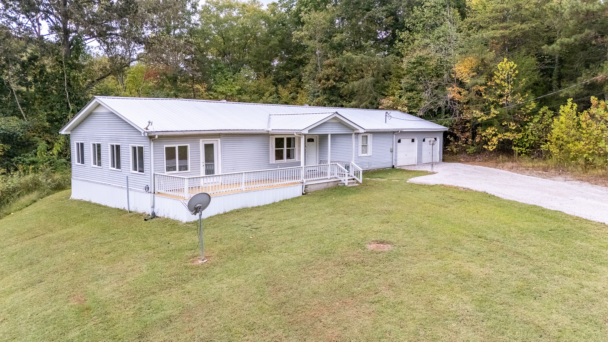 715 Springer Road Hohenwald, TN 38462 - Photo 30 of 30 a view of a house with a yard and fence