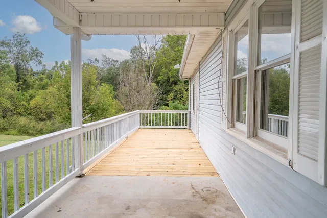 a view of a balcony with wooden floor