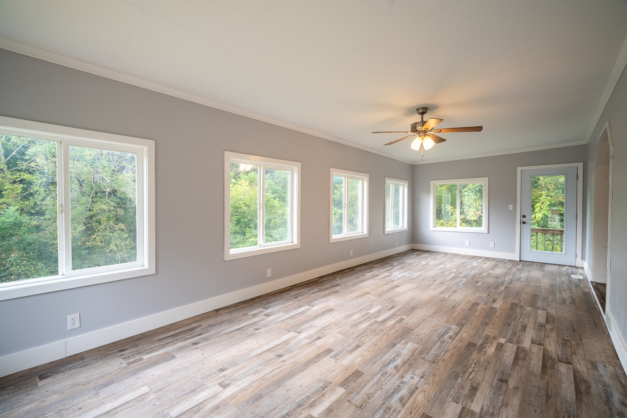 715 Springer Road Hohenwald, TN 38462 - Photo 10 of 30 a view of an empty room with a window and wooden floor
