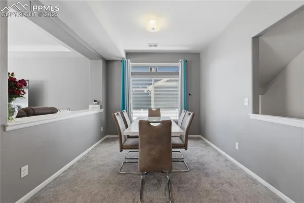 a dining room with furniture and window