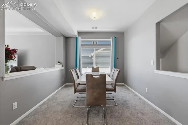 a dining room with furniture and window