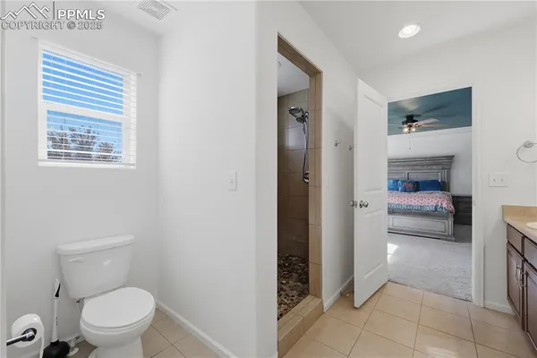 a bathroom with a toilet and a shower