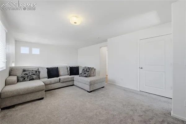 a living room with furniture and white walls