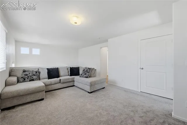 a living room with furniture and white walls