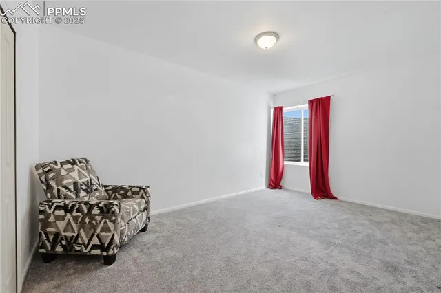 an empty room with furniture and a potted plant