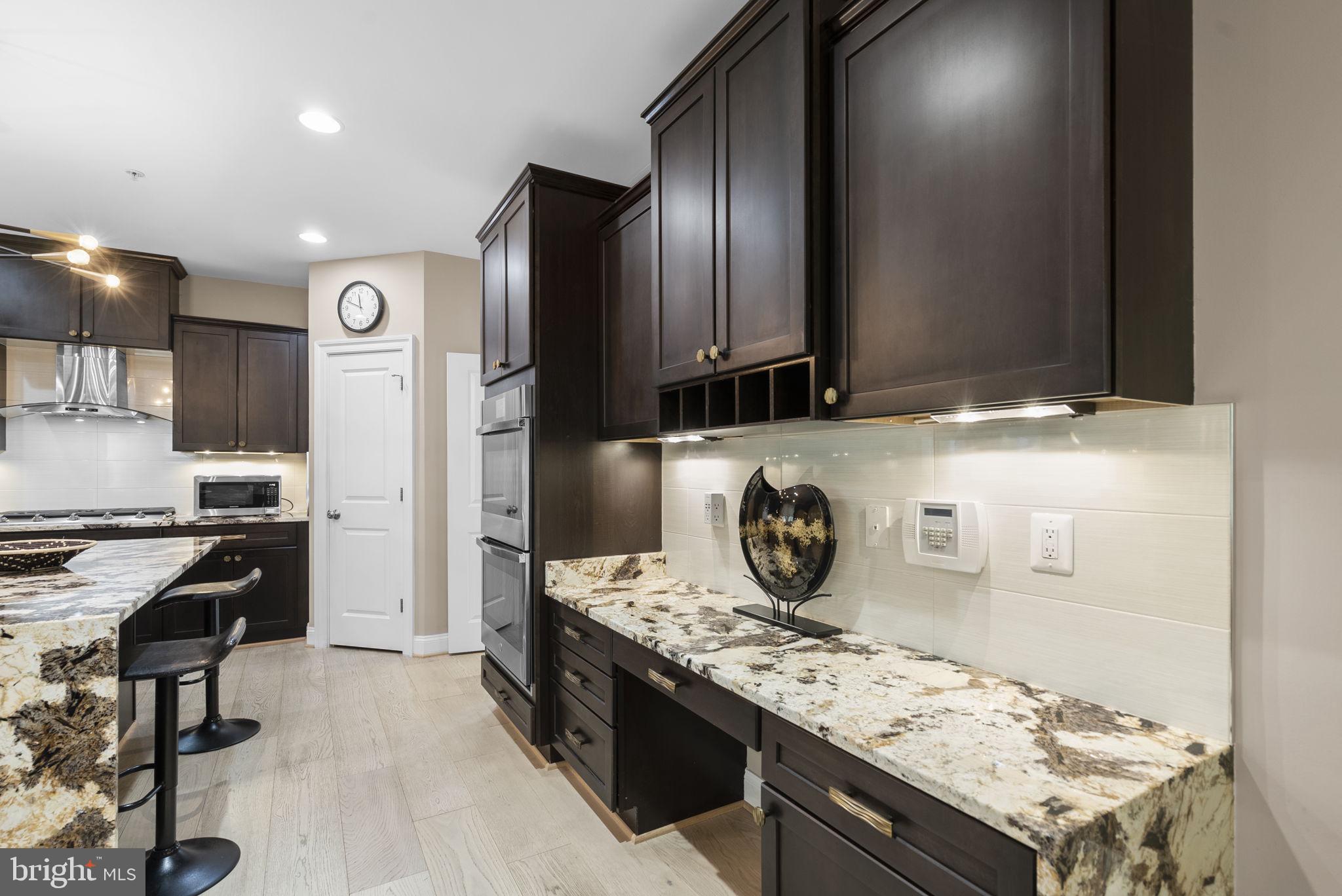 4702 Edgefield Road Bethesda, MD 20814 - Photo 16 of 58 Sleek modern kitchen with elegant finishes.