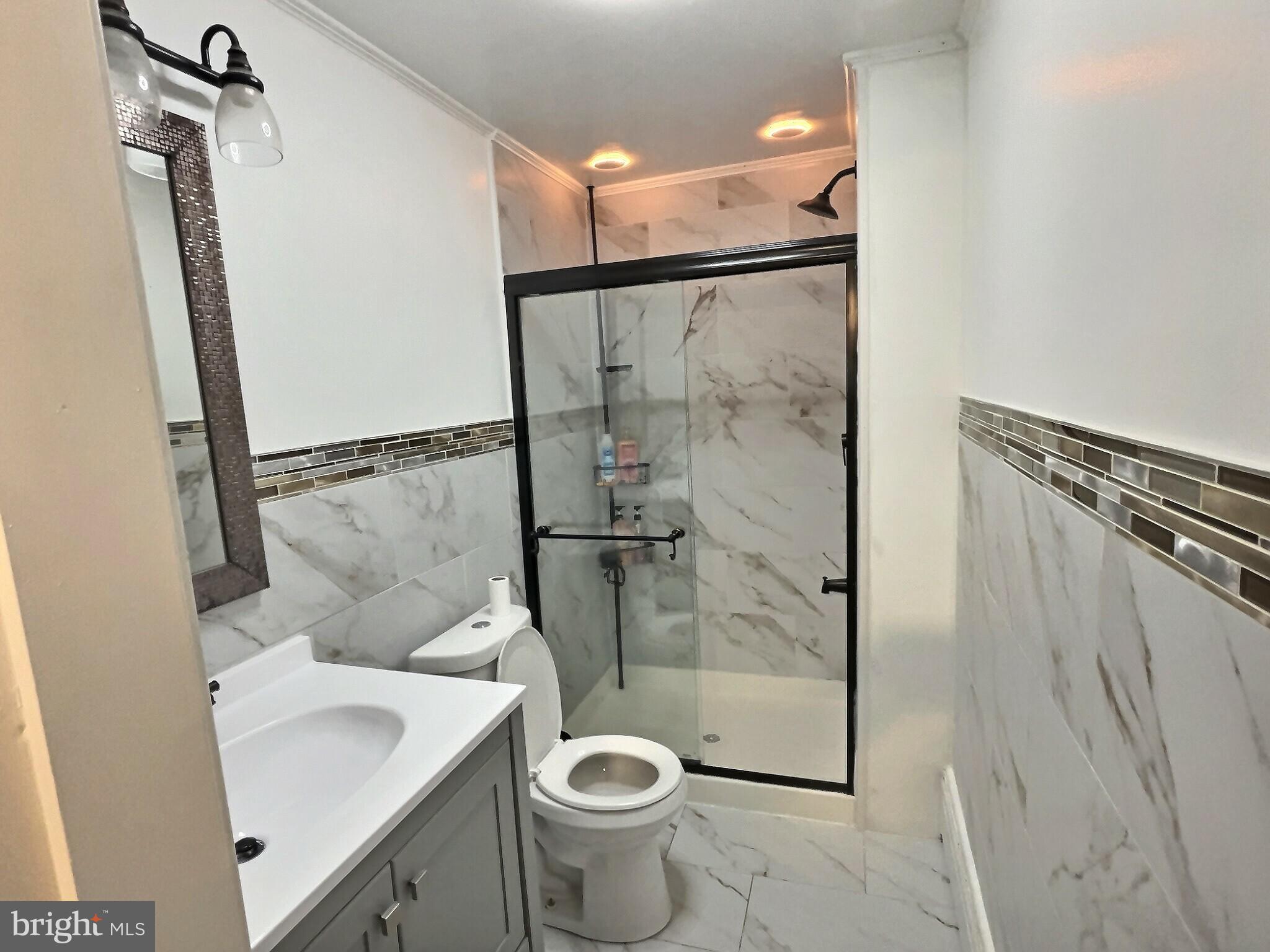 923 Fern Avenue Reading, PA 19607 - Photo 8 of 12 a bathroom with a sink a toilet and shower