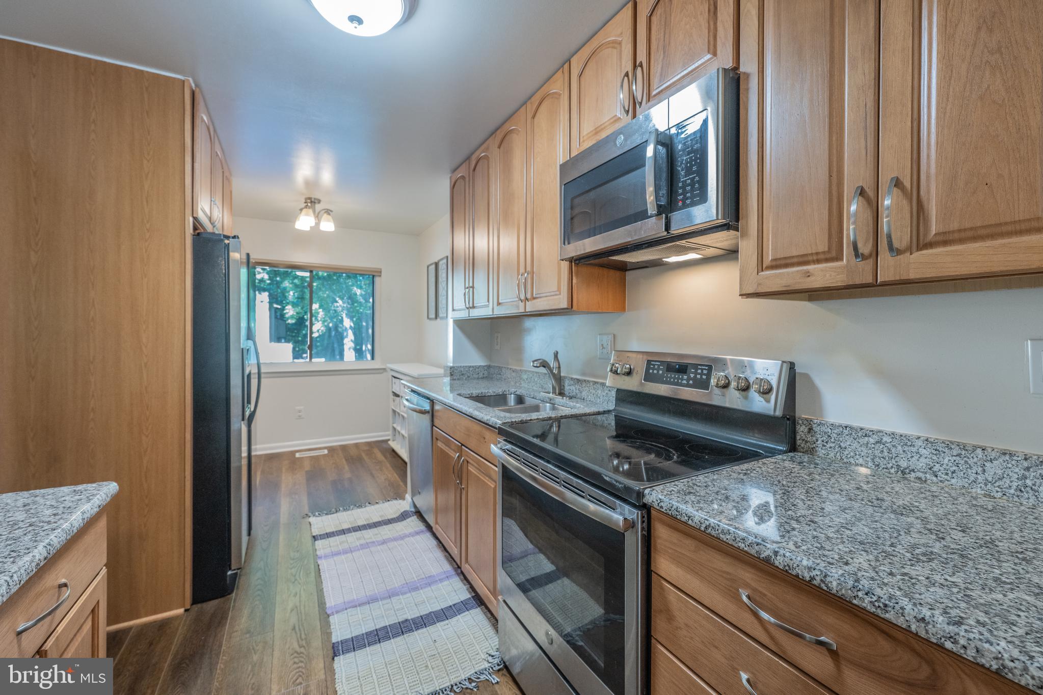 11917 Barrel Cooper Court Reston, VA 20191 - Photo 2 of 59 a kitchen with stainless steel appliances granite countertop a stove a sink and a microwave