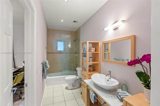 a spacious bathroom with a toilet sink and shower