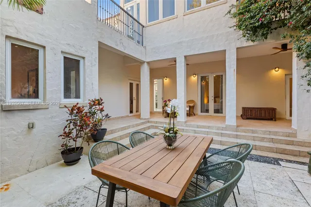 a vase of flowers sitting on a wooden floor