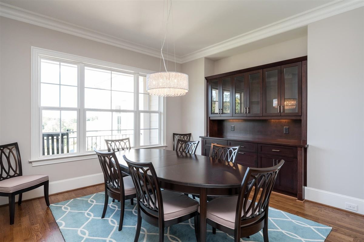 12904 Grovehurst Drive Raleigh, NC 27613 - Photo 5 of 30 Stunning modern lighting accents this spacious dining room with built in lighted buffet/china cabinet. Seat 8 + easily ! Scenic views! Dining Room