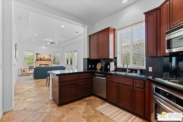 a bedroom with a bed a couch and a window