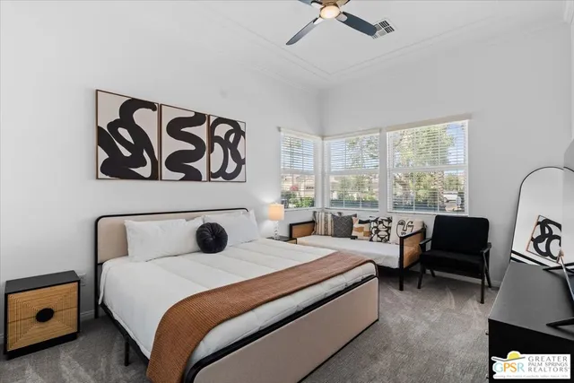 a bedroom with two beds and painting on the wall