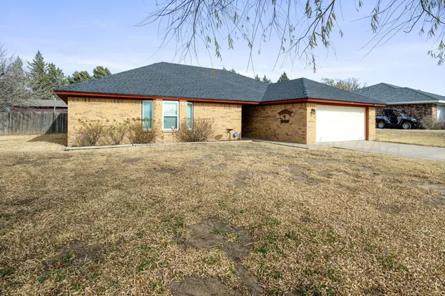 a view of large house with a yard and garage