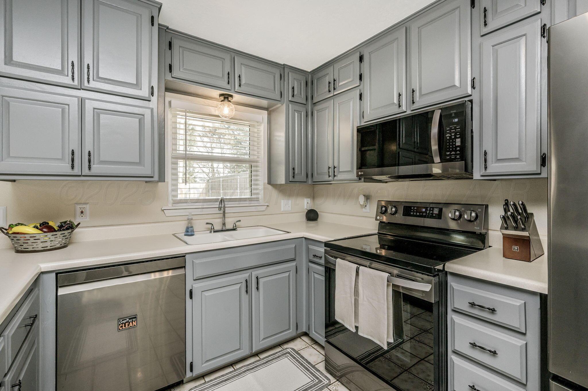 106 Del Norte Fritch, TX 79036 - Photo 4 of 21 a kitchen with a sink stove and microwave