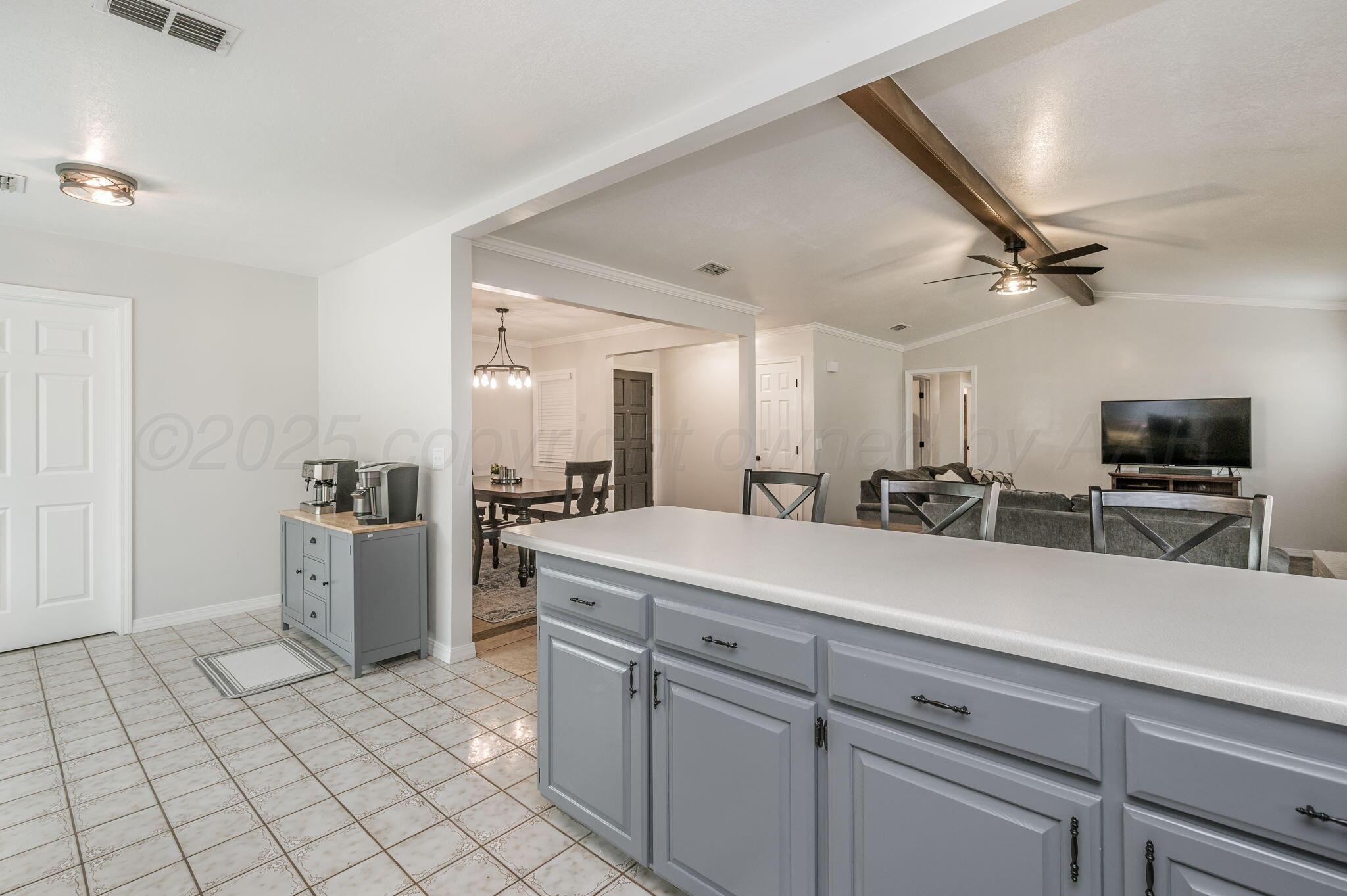 106 Del Norte Fritch, TX 79036 - Photo 5 of 21 a view of a kitchen with a sink wooden floor and windows