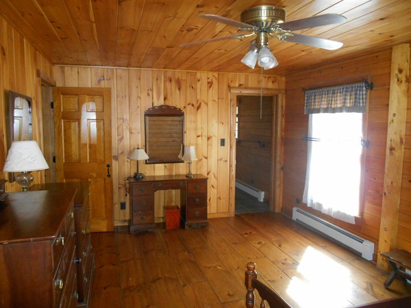 206 County Road Woodstock, CT 06281 - Photo 21 of 24 a view of a hallway with wooden floor windows and a chandelier