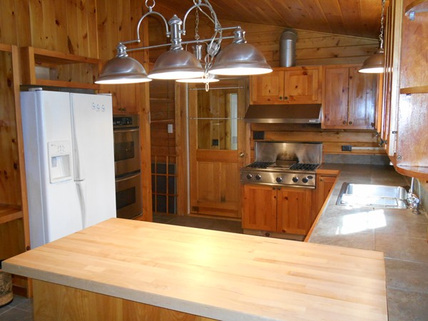 206 County Road Woodstock, CT 06281 - Photo 6 of 24 a kitchen with stainless steel appliances kitchen island granite countertop a refrigerator and a stove top oven