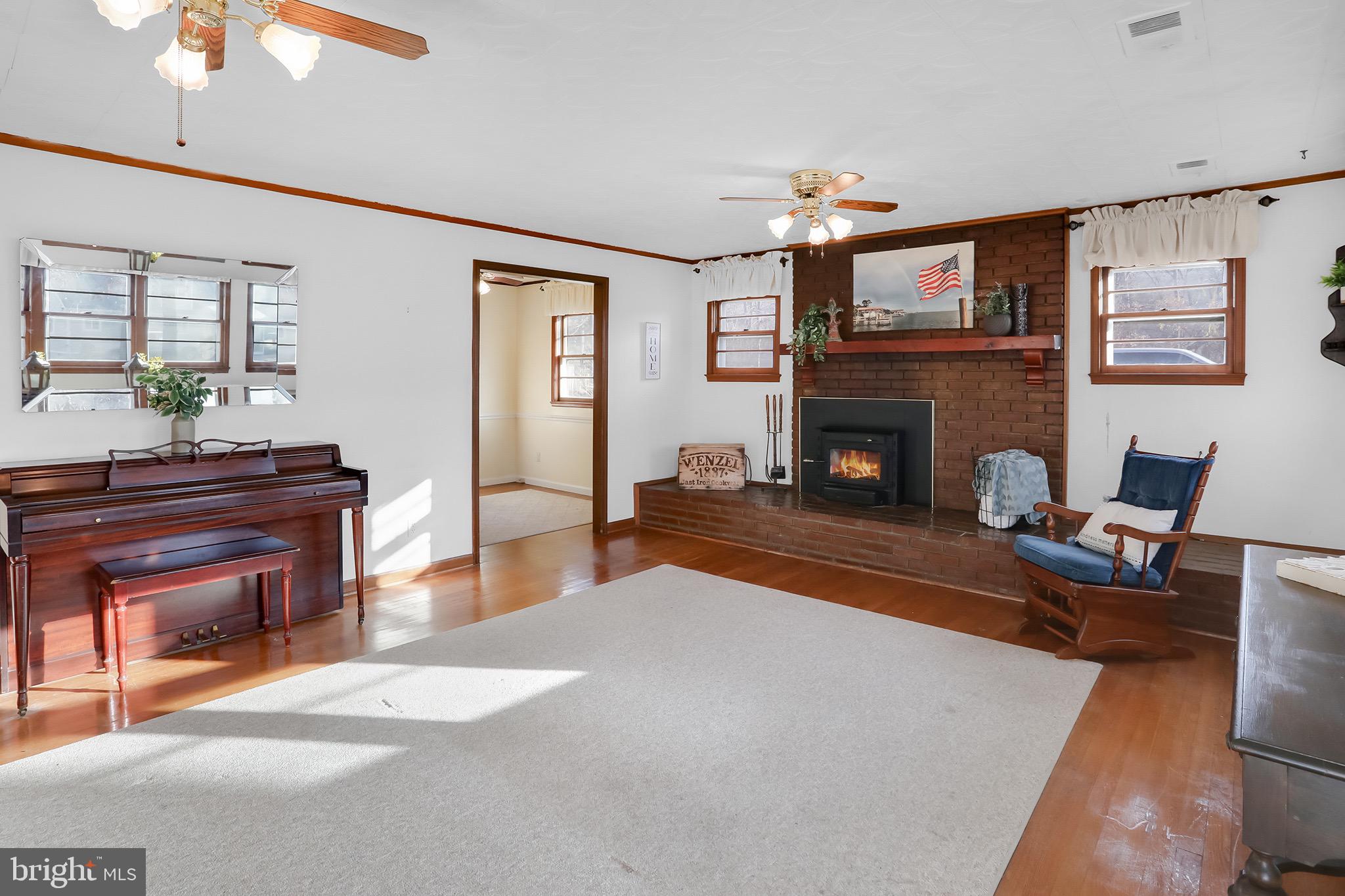 56 Ridgewood Lane Front Royal, VA 22630 - Photo 13 of 49 a living room with furniture a fireplace and a flat screen tv