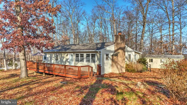 a view of balcony with wooden floor and fence