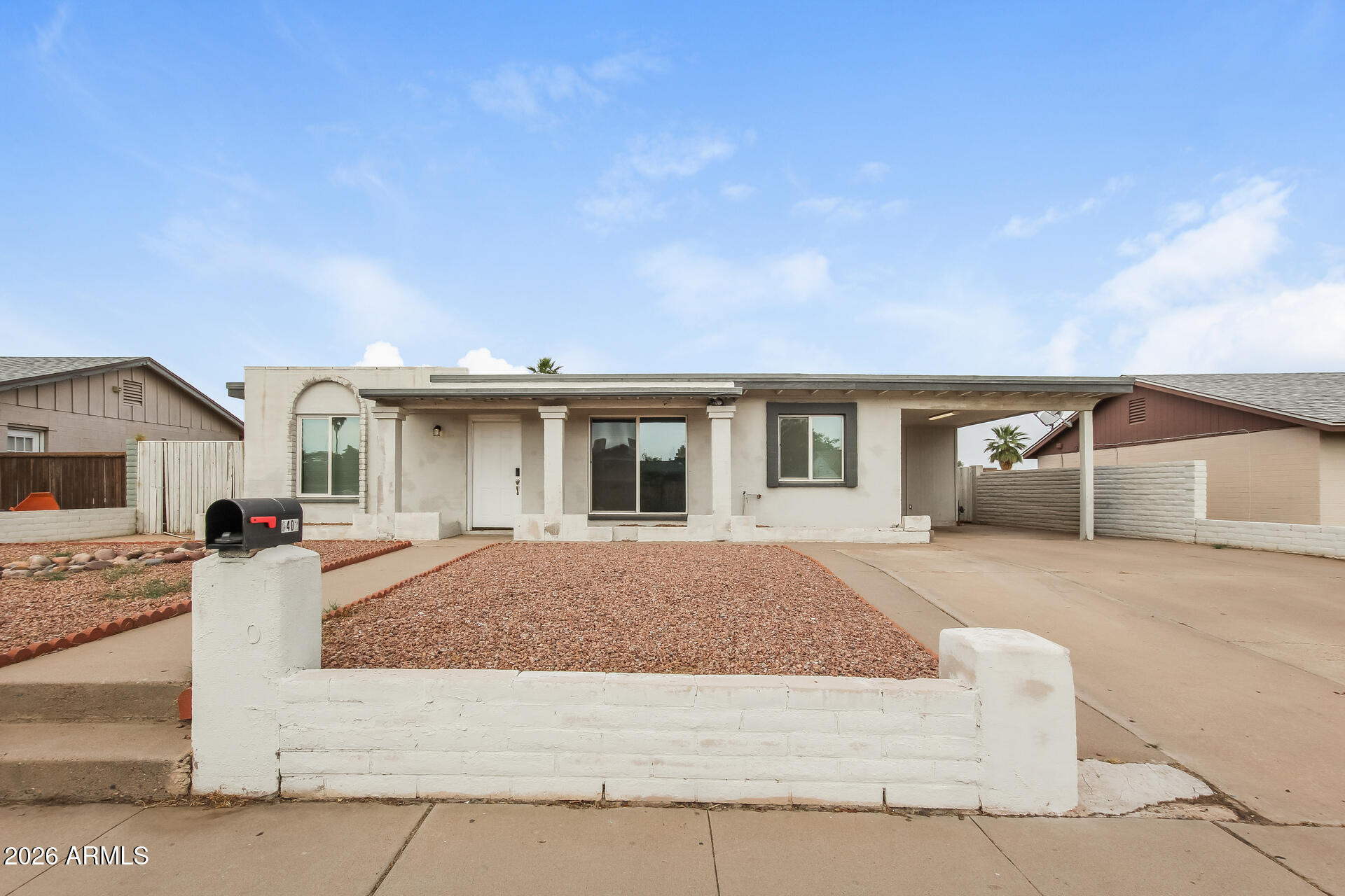 6402 South 44th Street Phoenix, AZ 85042 - Photo 1 of 20 a front view of a house with a garden and yard