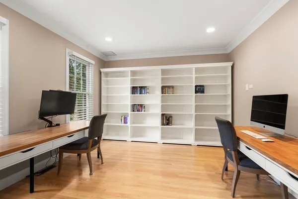 a view of a workspace with furniture and wooden floor