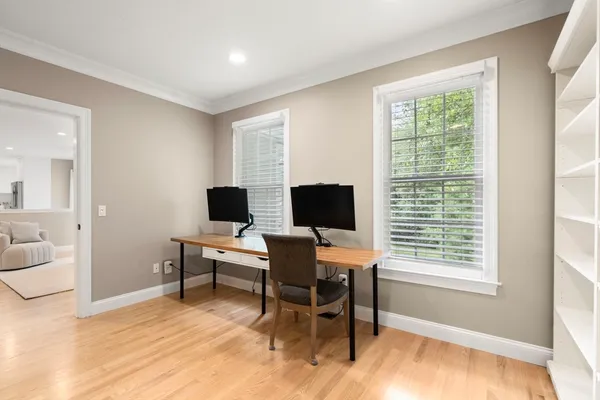 a view of a workspace with furniture and a window