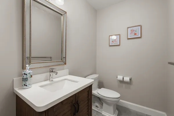 a bathroom with a sink toilet and a mirror