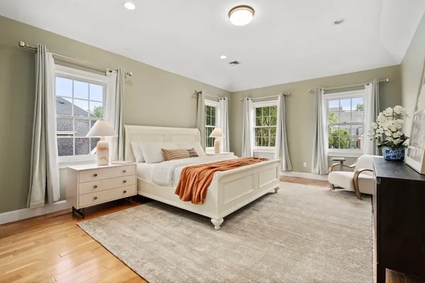 a spacious bedroom with a bed and a large window