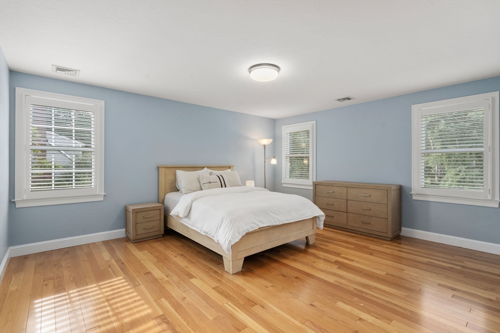 21 Cedar Springs Lane Needham, MA 02492 - Photo 24 of 31 a spacious bedroom with a bed and a window