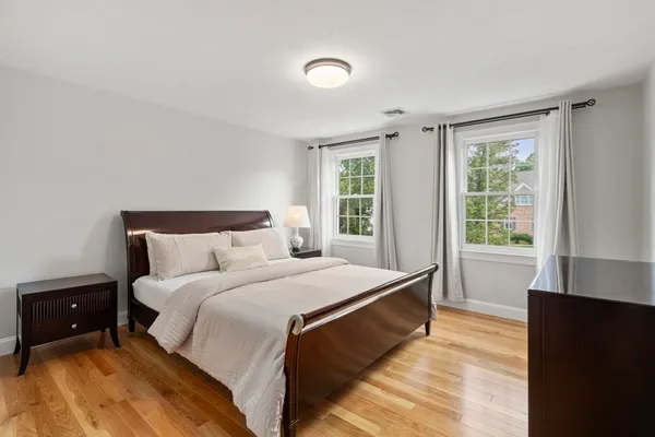 a bedroom with a bed and a large window