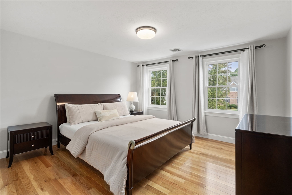 21 Cedar Springs Lane Needham, MA 02492 - Photo 25 of 31 a bedroom with a bed and a large window