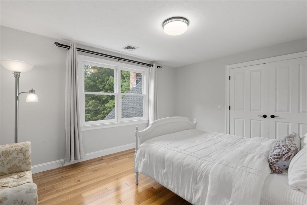 21 Cedar Springs Lane Needham, MA 02492 - Photo 27 of 31 a bedroom with a bed and a window