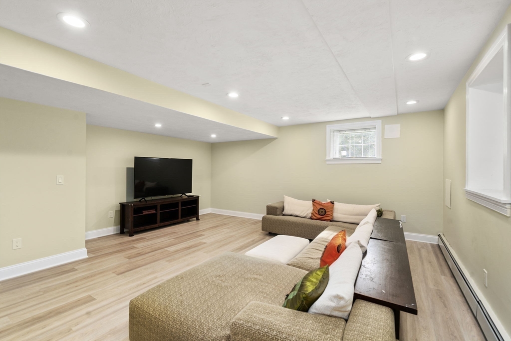 21 Cedar Springs Lane Needham, MA 02492 - Photo 29 of 31 a living room with furniture and a flat screen tv