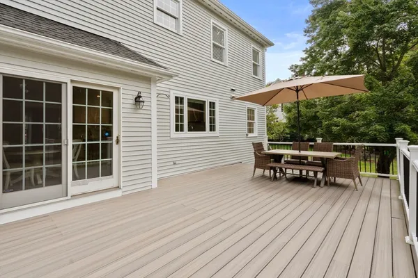 a backyard of a house with wooden floor and outdoor seating