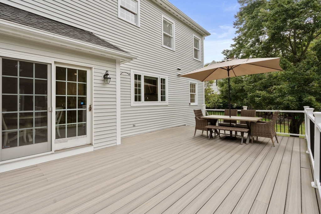 21 Cedar Springs Lane Needham, MA 02492 - Photo 30 of 31 a backyard of a house with wooden floor and outdoor seating