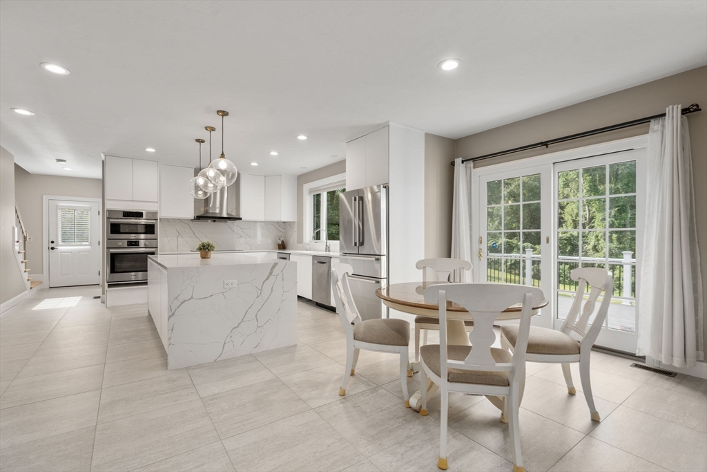 21 Cedar Springs Lane Needham, MA 02492 - Photo 7 of 31 a view of kitchen with dining table and chairs