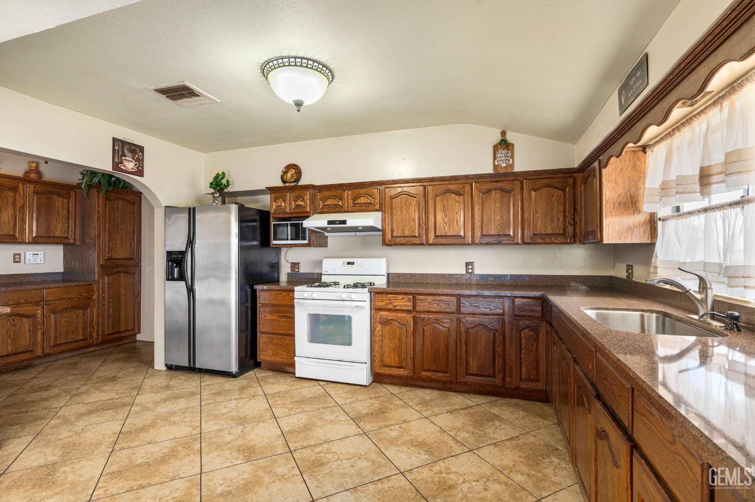 Undisclosed Address Delano, CA 93215 - Photo 14 of 72 a kitchen with granite countertop a sink cabinets and stainless steel appliances