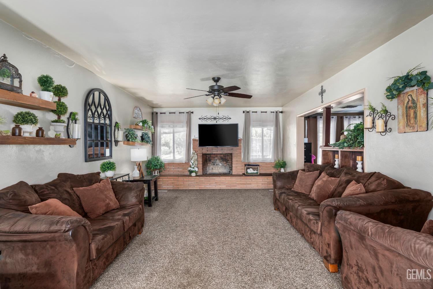 Undisclosed Address Delano, CA 93215 - Photo 16 of 72 a living room with furniture fireplace and flat screen tv