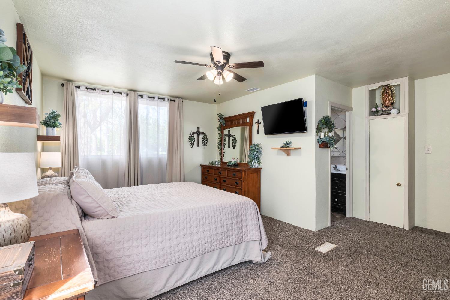 Undisclosed Address Delano, CA 93215 - Photo 20 of 72 a bedroom with a bed and a flat screen tv