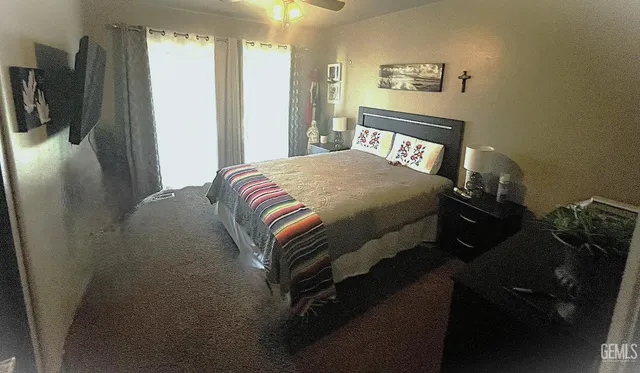 a view of a bedroom with furniture and windows